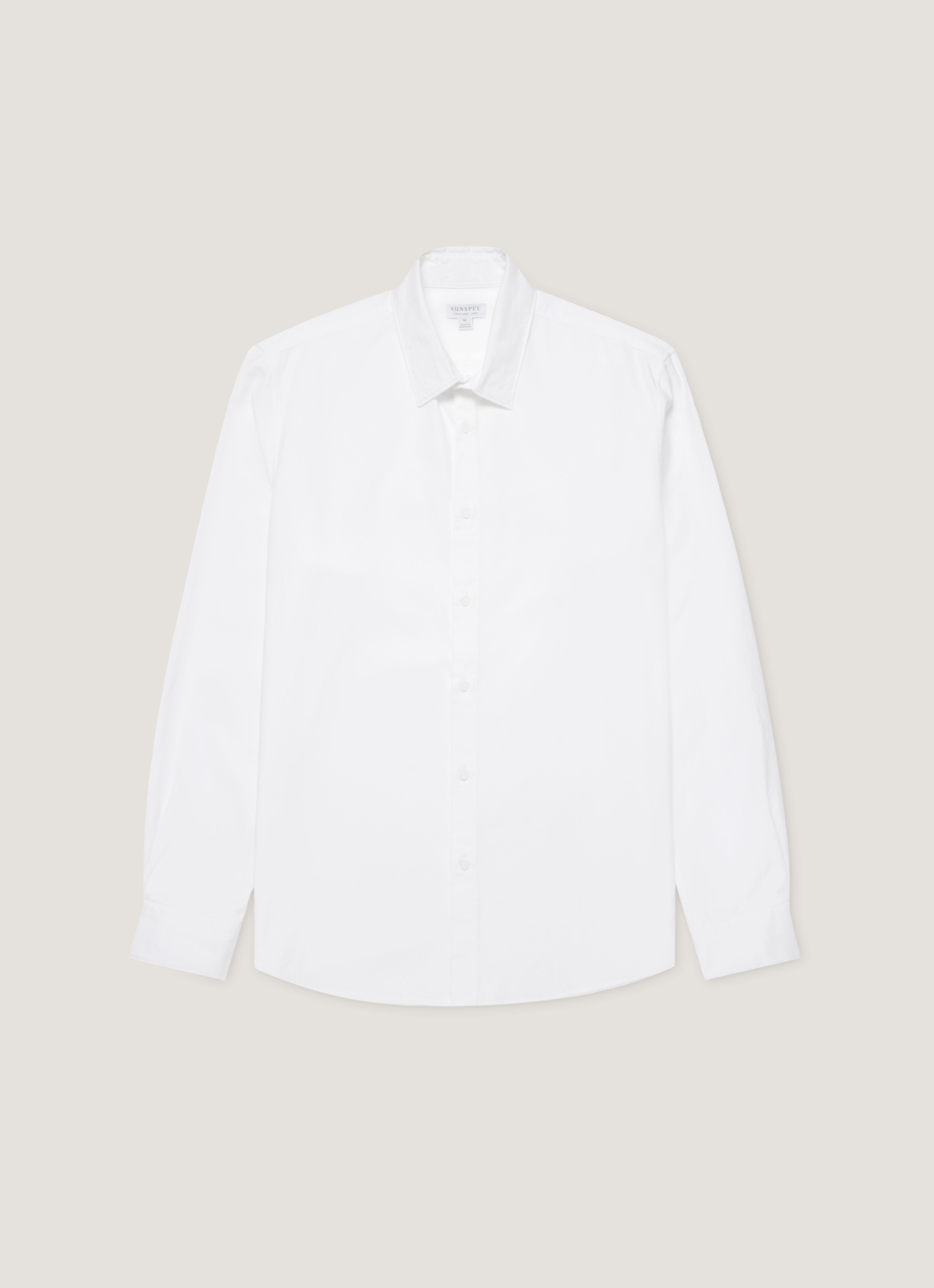 A white oxford cotton shirt with a button-down collar, shown flat.